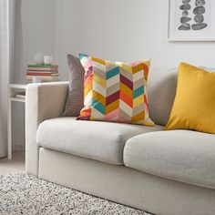 a white couch with colorful pillows on it