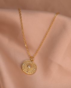 The Sianna necklace is a stunning circle shaped necklace that shines brightly with any outfit. The simplistic beauty of the pendant on the bold chain makes it the perfect piece to wear from work to a night out, or layered with other Stavi Sol necklaces! Chain 24K Gold Filled Rolo Chain Length: 20” inches Charms: 24K Gold Filled 15mm x 15mm Gold Plated Round Medallion Necklace, Gold Circle Necklace With Delicate Chain, Gold Circular Charm Necklace With Adjustable Chain, Gold Plated Medallion Necklace With Adjustable Chain, Gold Coin Necklace With Chain, Gold Plated Circle Necklace With Adjustable Chain, Gold Round Medallion Necklace, Gold Round Coin Necklace With Chain, Gold Plated Round Pendant Coin Necklace