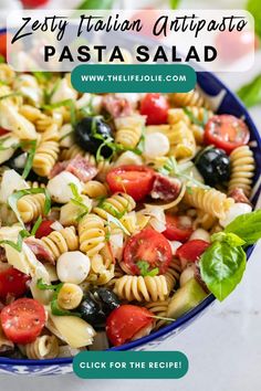 pasta salad with tomatoes, olives and mozzarella in a blue bowl