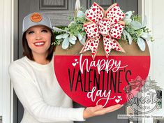 a woman holding up a valentine's day sign