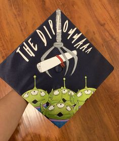 a graduation cap with the words the disporanma on it is being held by someone's hand