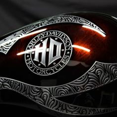 a close up of a motorcycle helmet on a black background with an intricate design around it