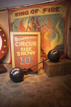 an old circus poster and balls on display