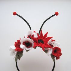 a headband with red and white flowers on it