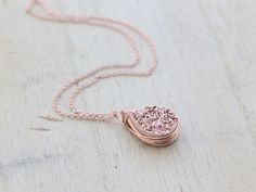 A high quality, genuine Druzy Quartz teardrop gilded in a rose gold titanium finish, is generously secured in my signature bezel wrapped style in 14k rose gold filled wire and suspended from delicate yet very sturdy 14k rose gold filled chain that I've hand finished for added durability. This necklace is a gorgeous piece that wears well alone or layered with other pieces. It would look fantastic with a hand stamped piece like this: https://www.etsy.com/listing/151477068/gold-bar-necklace-persona Rose Gold Copper Round Necklace, Rose Gold Copper Round Necklaces, Rose Gold Round Necklaces, Rose Gold Wire Wrapped Necklace, Rose Gold Copper Jewelry For Anniversary, Anniversary Rose Gold Copper Jewelry, Anniversary Rose Gold Wire Wrapped Jewelry, Geode Jewelry, Druzy Jewelry