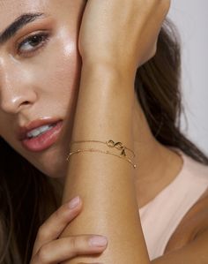 Design your own layered look for your bracelets with this dainty layering bracelet in gold. The chains are dainty and glistening, making it the perfect bracelet(s) for a special occasion as well as everyday wear. DETAILS: Model is wearing a 14k gold plated adjustable bracelet with an infinity pendant with a initial hanging charm, and a an adjustable satellite bracelet. *All bracelets are adjustable to fit multiple wrist widths. For a specific bracelet length just leave your request in the person Trendy Infinity Jewelry, Adjustable Delicate Chain Charm Bracelet, Dainty Beaded Bracelets For Friendship, Dainty Infinity Jewelry For Friendship, Dainty Infinity Friendship Jewelry, Elegant Charm Bracelet With Bracelet Strap For Friendship, Elegant Charm Bracelet For Friendship, Delicate Chain Beaded Bracelets As Gift, Minimalist Infinity Bracelet