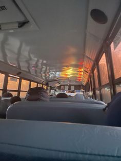 the inside of a bus with lots of seats and lights on it's ceiling