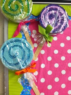 some lollipops are wrapped in plastic and sitting on top of a table