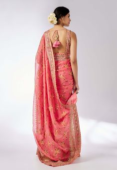 Embrace elegance with this delicate floral jaal sari, featuring layered frills, flounce, and an intricately embroidered border. The easy wrap design is complemented by a classic sleeveless printed blouse that adds a touch of glamour and glitz, making this ensemble perfect for any special occasion. Traditional Wear With Ruffles And Traditional Drape, Pink Georgette Blouse Piece With Ruffles, Traditional Silk Pre-draped Saree With Ruffles, Pink Saree With Ruffles, Pink Saree Blouse Piece With Ruffles, Designer Pink Ruffled Blouse Piece, Festive Pink Pre-draped Saree With Ruffles, Traditional Drape Wear With Ruffles For Festivals, Traditional Wear With Ruffles And Traditional Drape For Festivals