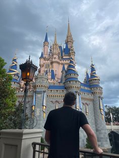 a man standing in front of a castle