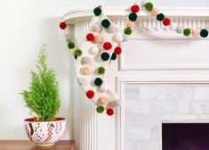 a christmas stocking hanging from a mantel with pom - poms on it