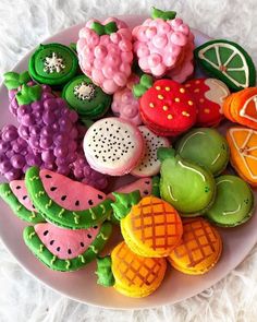 a plate filled with lots of different types of cookies on top of a white blanket