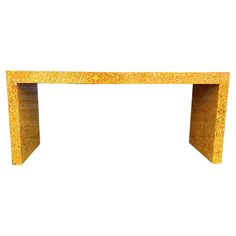 an orange table with gold glitter on it's top and bottom shelf, against a white background