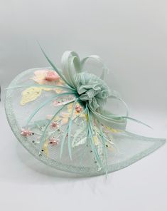 Stunning Mint Green Plink Wedding Fascinator Hat Duck Egg Blue Accents  Size 30.5 x 23cm head band or hair clip attachment  Perfect mother-of-the-bride wedding day accessory.   Elegant addition for those on the day essentials. matching Clutch Bag and Shoes available Elegant Spring Ceremony Hair Accessories, Elegant Hair Accessories For Spring Ceremonies, Elegant Wedding Hats And Headpieces With Handmade Flowers, Wedding Costume Hats And Headpieces With Handmade Flowers, Elegant Adjustable Fascinator With Flower Decoration, Spring Wedding Headband With Pinched Crown, Elegant Flower Headpieces For Gifts, Elegant Flower Hair Accessories For Kentucky Derby, Spring Ceremony Headband Fascinator