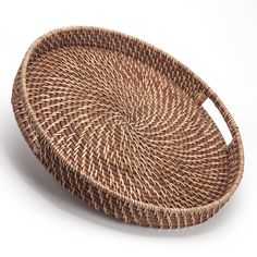 a round woven basket on a white background