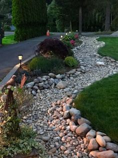 a garden with rocks and lights in the middle