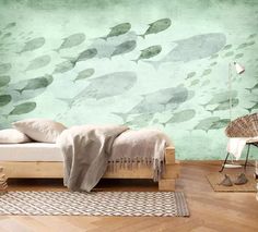 a bed sitting in a bedroom next to a wall with fish painted on the walls