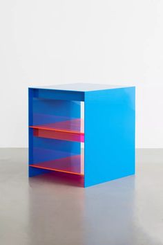 a blue and red shelf sitting on top of a floor