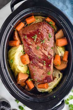 slow cooker corned beef with carrots, cabbage and leeks in it