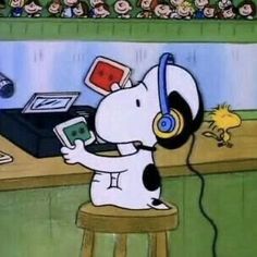 a cartoon dog with headphones on sitting at a desk