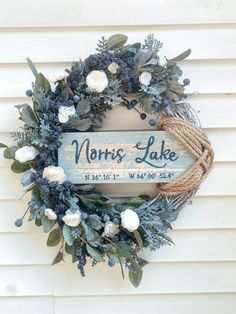 a wreath that is hanging on the side of a building with a sign saying north lake