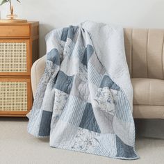 a living room with a couch and a blanket on the floor