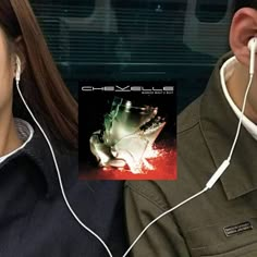 a man and woman are listening to headphones