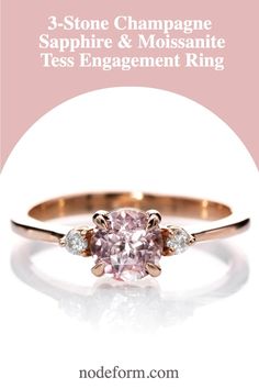 a pink diamond engagement ring with the words 3 stone champagne sapphire and moissanite tees engagement ring