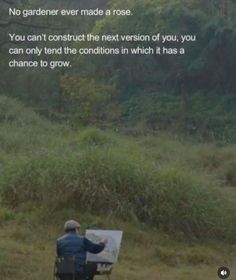 a man sitting in a chair next to a forest holding a paintbrush and looking at the ground