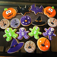 decorated cookies are arranged in the shape of witches, pumpkins and jack - o'- lanterns