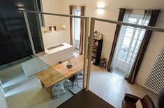 an aerial view of a kitchen and living room from the second floor looking down at the dining area