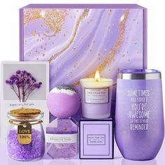 a purple gift set with candles, soaps and bath salts in a glass jar