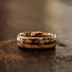 two wedding rings sitting on top of a wooden table