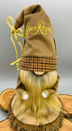 a stuffed animal wearing a brown hat on top of a piece of wood with the word crump road written on it