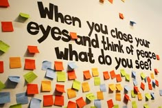 a wall covered in post it notes with words written on them