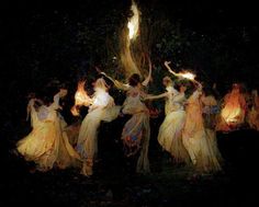 a group of women dressed in white dancing around a tree with fire on their hands