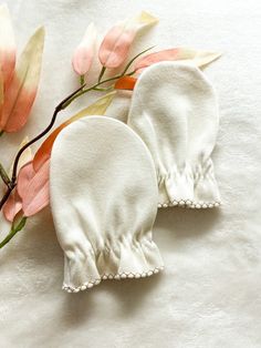 Our Certified Organic Cotton Baby Mittens are the perfect addition to your baby's wardrobe! Made with the highest quality, GOTS-certified organic cotton, these mittens are soft, gentle, and safe for your baby's delicate skin. Our one-size design is intended to fit babies from newborn to 6 months, while the adorable minimalist designs add a touch of style and charm. And with their breathable and moisture-wicking properties, our mittens will keep your baby's hands dry, comfortable, and protected a Newborn Mittens, Baby Gloves, Baby Mittens, Pink Apple, Newborn Sets, Baby Hands, Minimalist Designs, Organic Cotton Baby, Hospital Bag