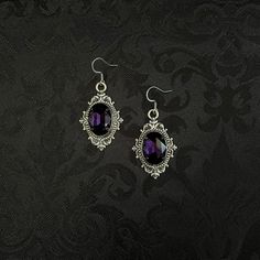 "These richly detailed earrings are made with antiqued silver tone settings. Their captivating design is accented with dark amethyst purple glass jewels.  Earrings measure 2\" in length (including stainless steel hooks) and 1\" wide.  Matching chokers are listed separately in our store. If you don't see items with a color you want, feel free to ask about availability." Black And Purple Vampire Aesthetic, Dark Purple Jewelry Aesthetic, Purple And Black Earrings, Purple Accessories Jewelry, Purple And Black Jewelry, Purple Prom Accessories, Goth Victorian Wedding, Dark Purple Accessories, Dark Purple Jewelry