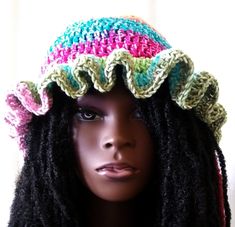 a mannequin head wearing a crochet hat with dreadlocks on it