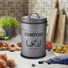 a metal pail sitting on top of a counter filled with vegetables