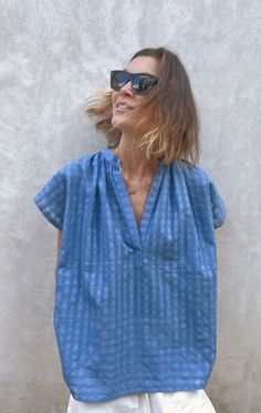 Our signature shirt Easy to wear from beach to city. We promise this top will be your go-to warm weather item. Perfect under a blazer. Very Slightly sheer and gets softer with every wash. This fabric has a nice crisp finish to it and looks elegant. Color: Chambray Blue Grid — Length 27" and Width 26.5" — One size Blue Grid, Elegant Color, Chambray, Warm Weather, Shirts Tops, Shirt Blouses, Top Blouse, Blouses, Blazer