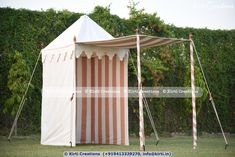 a large tent is set up in the grass with two poles sticking out of it