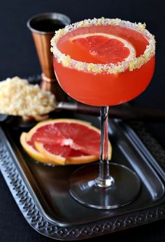 a grapefruit margarita on a black tray