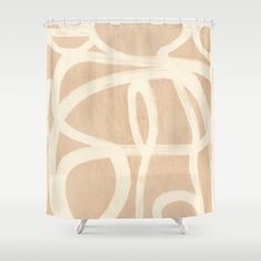 a shower curtain with an abstract design in beige and white on the outside, featuring circles