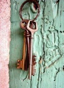 an old key hangs on the side of a door