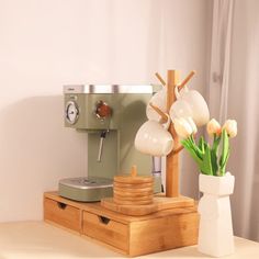 a coffee machine and some flowers on a table