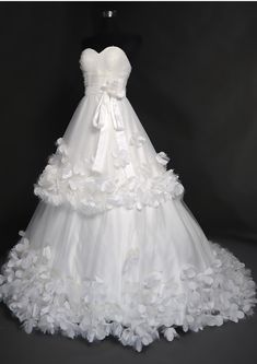 a white wedding dress with flowers on it