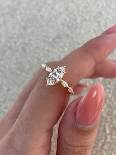 a woman's hand with a ring on it and a diamond in the middle