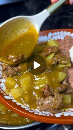 a person is spooning some food out of a bowl on a plate with rice