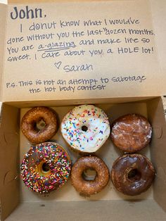 a box filled with lots of donuts next to a handwritten note